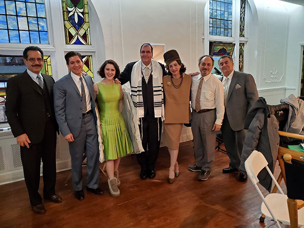 Cantor Philip Sherman, at center, poses with the stars of “The Marvelous Mrs. Maisel,” on which he had a consulting role in 2022.